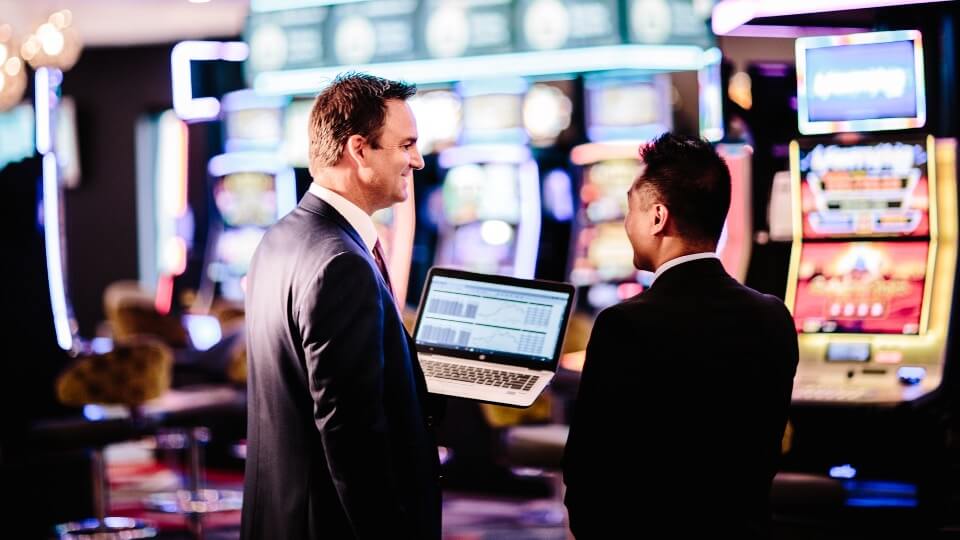 A MAX representative and a venue manager in a gaming room